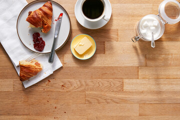Overhead Flat Lay Shot Of Table Laid For Breakfast Croissant And Coffee