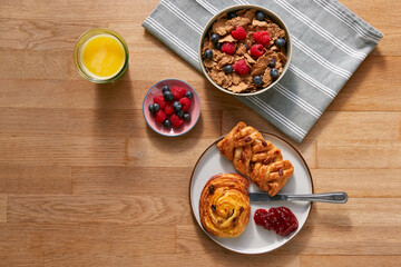 Overhead Flat Lay Shot Of Table Laid For Breakfast With Cereal Pastries And Coffee