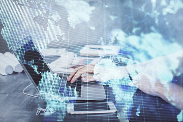 Multi exposure of businessman working on laptop on background. International business hologram in front. Concept of success.