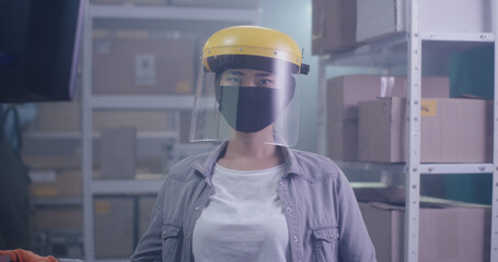 Woman wearing protective gear in warehouse