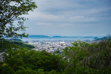 Naklejka na ściany i meble 松山市の風景と奥に見える海