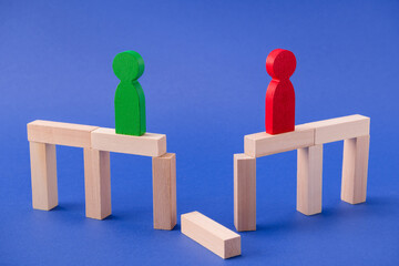 Two lonely wooden figures friends leaders entrepreneurs lovers standing on broken bridge striving...