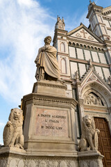 Firenze, Basilica of Santa Croce. Detail of the Dante Alighieri's statue closed to the gothic churc