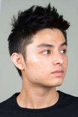 Naklejka premium Face of young handsome Asian man thinking