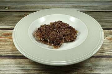 Pile of rice cracker, deep fried mix cooked brown rice and rice berry on the plate. Traditional preserved rice in Asia. Famous snack in ancient party. 