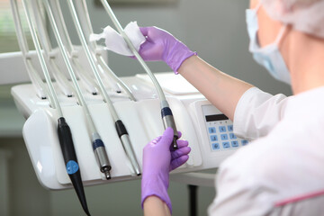 A nurse wipes dental instruments. An unrecognizable photo.The concept of health. Copy of the space.Top view.