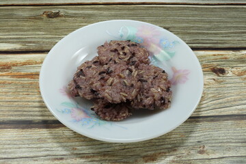 Pile of rice cracker on the plate, famous sweet dessert in Asia. Piece of cooked rice stack, local snack in ancient festival. 