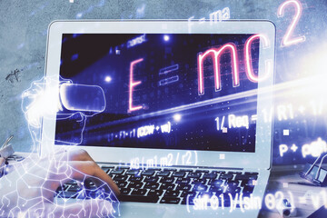 Science formula hologram with man working on computer on background. Education concept. Double exposure.
