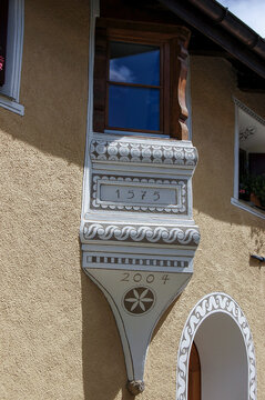 Small balcony with wooden windows in the ancient village of Zuoz, tourist resort in Engadin valley, Graubunden canton, Maloja region, Switzerland, Europe