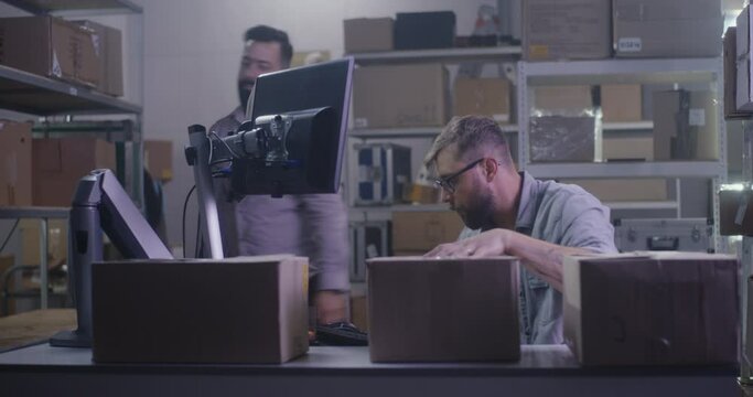 Worker handling packages in distribution center