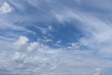 Skydiving. A parachute is in the sky.