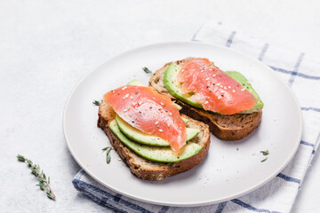 Open sandwich with avocado, smoked salmon and rye bread.