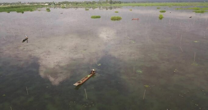 Fisherman On The Fishing Boat In Loktak Lake. Floating Lake In The World Located In Moirang, Manipur, Northeast India.  - aerial drone
