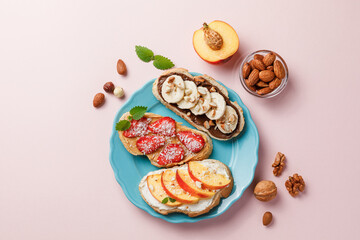 Sweet sandwiches with fruits and berries on pink colorful background.