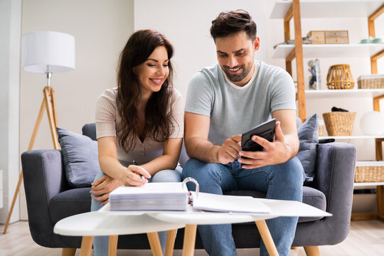 Happy Family Using Calculator For Tax