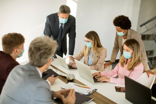 Group business people have a meeting and working in office and wear masks as protection from corona virus