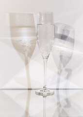 transparent glass with carbonated liquid on a white background and multiplied shadow