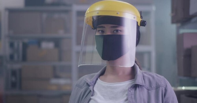 Woman wearing protective gear in warehouse