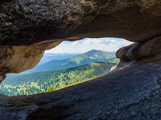 View through a window in the rock in the Natural Park Ergaki. Siberian wildlife
