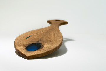 Beautiful carved wooden cutting Board on a white background, made by your own hands.For cooking and decorating the interior of the kitchen area.