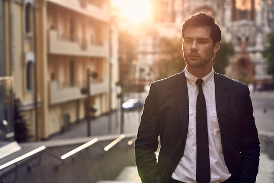 Young and successful. Handsome young man in full suit posing while standing outdoors.