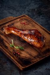 Grilled  turkey leg in barbecue sauce on a wooden chopping Board