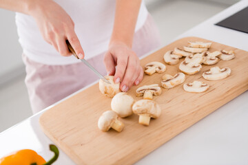 Cropped close up photo of girl prepare delicious veggie menu cut raw fresh organic mushroom knife...