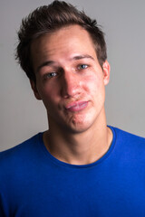 Fototapeta premium Face of young handsome man making face