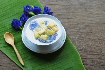 
Sago and  cantaloupe in coconut milk on  banana leaf  prepare for serving  in the  kitchen  , Thai  dessert  image for background , selective focus .
