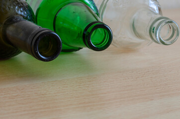 Close-up of three glass bottles with dust and dirt.
