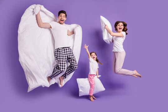 Full length body size view of cheerful glad carefree funny family small little daughter jumping having fun bedtime weekend isolated on bright vivid shine vibrant violet color background