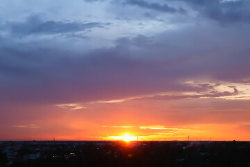 Aerial dramatic atmosphere view of summer twilight natural image background with sunset on horizontal skyline and colorful tropical sky and clouds.