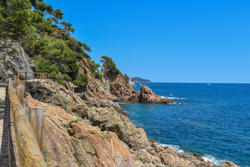 Fototapeta na wymiar Costa brava spain, stone path next to mountains with sea views