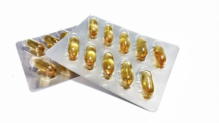 blister pack of pills.Rice bran and germ oil mixed with black sesame granules in blister pack foil. Healthy Supplements on white background