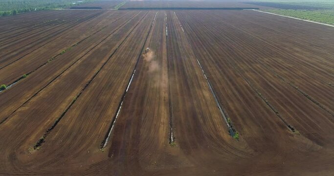 Peat harvesting in bog peat production fields aerial view