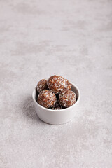 Raw food balls in a bowl with carob.