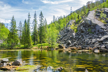 View of The Pyha-Luosto National Park in summer, rocks, stones, trees and natural pond, Lapland, Finland