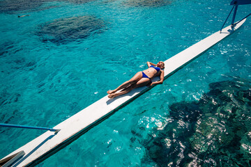 Obraz premium young woman in bikini posing upon water