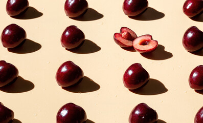 Sweet cherry on the yellow background pattern. Creative art food photo.