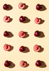 Sweet cherry on the yellow background pattern. Creative art food photo.