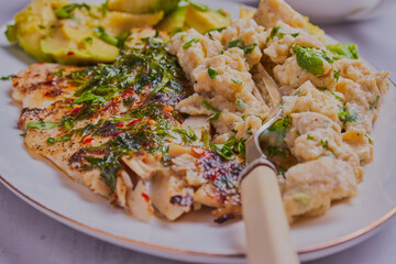 Healthy fish, scrambled eggs and avocado.