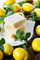 Authentic Shortcake Cake, a lot of fresh yellow lemons and mint. Morning atmospheric lighting, fashionable trendy spot soft focus. Preparation for design creative menu.