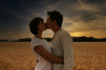 portrait of a couple kissing in a wheat field under a sunset
