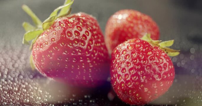 Macro view of red strawberries on dark background.Fresh and juicy berries to eat as dessert, snack, healthy eating concept, nutritious raw food,best for smoothie. Food blogging, advertising, packshot