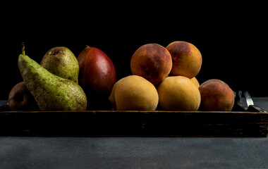 peaches and fruits on a rustic wooden tray
