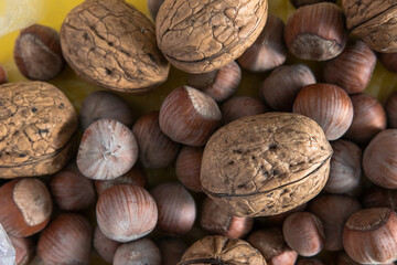 hazelnuts and walnuts lie in a transparent bag; top view, close-up