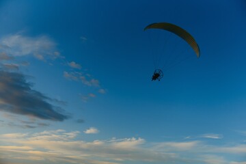 Fototapeta na wymiar Paraglider with yellow parachute taking off