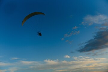 Paraglider with yellow parachute taking off