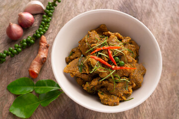 Stir Fried Mince Pork with Yellow Chili Curry Paste. Traditional local Southern Thai food. Hot and spicy pork curry with herbs, pepper, turmeric, chili, onion and kaffir lime leaves.