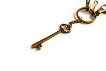 Old vintage antique golden key on white background.